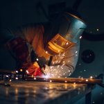 man-worker-welding-metal-with-welding-machine-in-a-factory-or-workshop.jpg